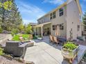 Spacious backyard featuring a patio with seating, a fire pit, and well maintained lawn at 10388 Lions Path, Lone Tree, CO 80124