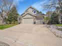 Charming two-story home with a well-manicured lawn and a spacious three car driveway at 10388 Lions Path, Lone Tree, CO 80124