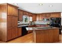 Modern kitchen with beautiful wood cabinets, granite countertops, and stainless steel appliances at 12739 W Alabama Pl, Lakewood, CO 80228