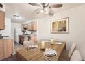 Dining room featuring wood table and seating, neutral walls, and kitchen access at 16259 W 10Th Ave # K1, Golden, CO 80401