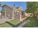 Backyard of stucco home with privacy fence and lush lawn at 2417 S Racine Way, Aurora, CO 80014