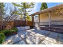 Outdoor patio featuring a built-in fire pit, stylish pavers, and lush landscaping, designed for relaxation at 2601 S Quebec St # 6, Denver, CO 80231