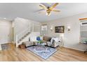 Bright living room featuring hardwood floors, modern decor, and a stylish area rug at 8335 Deframe Ct, Arvada, CO 80005