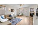 Bright living room featuring a cozy fireplace and lots of natural light at 8335 Deframe Ct, Arvada, CO 80005