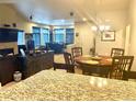 Open dining area with hardwood floors and stylish chandelier, flowing into the living space at 12604 Madison Way, Thornton, CO 80241