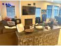 Cozy living room features a fireplace, a large TV, and comfortable seating at 12604 Madison Way, Thornton, CO 80241