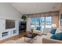 Bright living room with fireplace and large windows at 8182 S Winnipeg Ct, Aurora, CO 80016