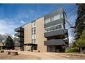Modern building showcasing sleek architecture with private balconies and manicured grounds at 675 S University Blvd # 106, Denver, CO 80209