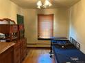 A bedroom with classic furnishings, a window with wooden blinds, and hardwood floors at 1337 Valentia St, Denver, CO 80220