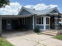 View of house exterior with a covered carport and view of the front entrance at 1337 Valentia St, Denver, CO 80220