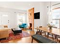 Cozy living room and dining area with exposed brick and a modern, open floor plan at 3534 Decatur St, Denver, CO 80211