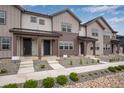 Charming townhomes featuring board and batten siding and inviting covered front porches, perfect for relaxation at 16774 W 93Rd Pl, Arvada, CO 80007