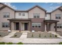 Charming townhomes featuring board and batten siding and inviting covered front porches, perfect for relaxation at 16774 W 93Rd Pl, Arvada, CO 80007