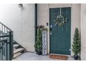 Inviting entryway with a dark green door, welcome sign, and festive wreath at 1727 N Pearl St # 201, Denver, CO 80203