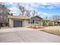 Well-kept ranch home with an attached garage and an ample driveway for multiple vehicles at 8543 W Arizona Dr, Lakewood, CO 80232