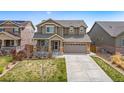Beautiful two-story home featuring a well-maintained lawn and a welcoming facade at 17052 Lipan St, Broomfield, CO 80023