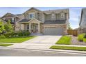 Inviting two-story home with a spacious driveway and beautifully landscaped front yard at 17052 Lipan St, Broomfield, CO 80023