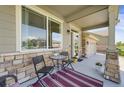 Inviting front porch with seating area, perfect for relaxing and enjoying the outdoors at 17052 Lipan St, Broomfield, CO 80023