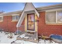 House entrance with brick facade and security door at 12152 E Dakota Ave, Aurora, CO 80012