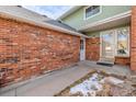 Exterior elevation showcasing the brick facade with snow on the side of the home at 1922 Lydia Dr # 82, Lafayette, CO 80026