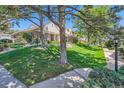Exterior showcasing the manicured lawn and landscaping that surrounds the home at 9925 W Progress Pl, Littleton, CO 80123