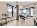 Bright dining area with a modern table set and expansive windows showcasing city views at 1750 Wewatta St # 704, Denver, CO 80202