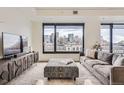 Bright living room with cityscape views, comfortable seating, and stylish furnishings at 1750 Wewatta St # 704, Denver, CO 80202