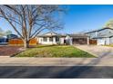 Charming single-story home with a lush green lawn and a detached two-car garage at 1014 Ponderosa Cir, Longmont, CO 80504