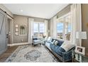 Stylish living room with large windows, natural light, comfortable seating, and scenic views at 10151 E 138Th Pl, Brighton, CO 80602