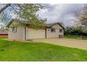 Spacious garage with extended driveway and fenced yard at 3000 Alkire St, Golden, CO 80401
