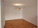 Bright dining room featuring beautiful parquet flooring, light walls, and vintage light fixture at 680 S Alton Way # 9A, Denver, CO 80247