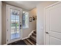 Bright entryway with stairs, door to patio, and coat closet at 9490 W 14Th Ave # 3, Lakewood, CO 80215