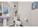 Small powder room with pedestal sink and toilet at 9490 W 14Th Ave # 3, Lakewood, CO 80215