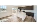 Modern kitchen with a large island, stainless steel appliances, and ample counter space at 16582 E 109Th Ave, Commerce City, CO 80022