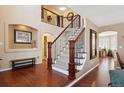 Elegant entryway with hardwood floors, staircase, and stylish decor at 6502 Shea Pl, Highlands Ranch, CO 80130
