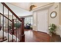 Inviting foyer with hardwood floors, a staircase and natural light at 6502 Shea Pl, Highlands Ranch, CO 80130