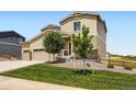 Charming two story home with a 3-car garage, manicured lawn, and stone accents at 42830 Ivydel St, Elizabeth, CO 80107