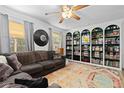 Bright living room with built-in bookcase and comfortable couch near a window offering natural light at 140 S Kendall St, Lakewood, CO 80226
