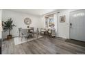 Inviting dining area with modern decor, a round table, and large windows with bright natural light at 6532 S Field Way, Littleton, CO 80123