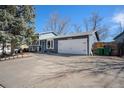 Lovely home featuring a two-car garage, blue exterior paint, and well-manicured landscaping at 6532 S Field Way, Littleton, CO 80123