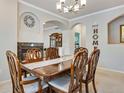 Elegant dining room with stylish chandelier and fireplace, perfect for formal gatherings and dinner parties at 15501 E 112Th Ave # 33D, Commerce City, CO 80022
