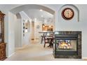 Open-concept living room with fireplace, archway, and view of the eat in kitchen at 15501 E 112Th Ave # 33D, Commerce City, CO 80022