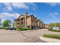 Apartment building exterior showing assigned parking, landscaping, and a view of the architecture at 15460 Canyon Gulch Ln # 105, Englewood, CO 80112