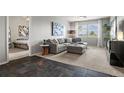 Inviting living room featuring a plush gray sectional sofa, carpet, and natural light at 15460 Canyon Gulch Ln # 105, Englewood, CO 80112
