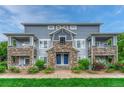Charming townhome with stone facade and double blue doors creates an inviting entryway at 5255 Memphis St # 1009, Denver, CO 80239