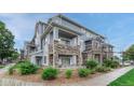 Attractive townhome featuring stone accents, inviting balconies, and manicured landscaping at 5255 Memphis St # 1009, Denver, CO 80239