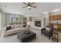 Comfortable living room with a fireplace, ceiling fan and open to kitchen area at 5255 Memphis St # 1009, Denver, CO 80239