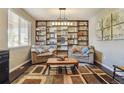 Inviting living room features custom shelving, wood floors and a cozy seating area at 4920 S Netherland Way, Centennial, CO 80015