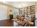 Comfortable living room with custom built-ins, hardwood floors and neutral color pallete at 4920 S Netherland Way, Centennial, CO 80015