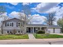 Charming gray two-story home with landscaped yard, mature trees, and a two car garage at 4358 S Alton St, Greenwood Village, CO 80111